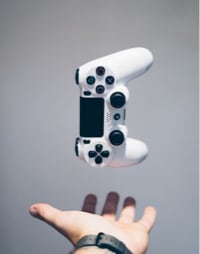 a white game pad above an open hand